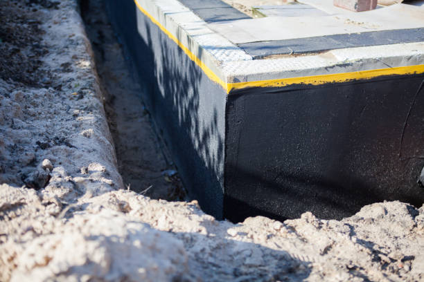 Professional Waterproofing technician working in Towson, MD